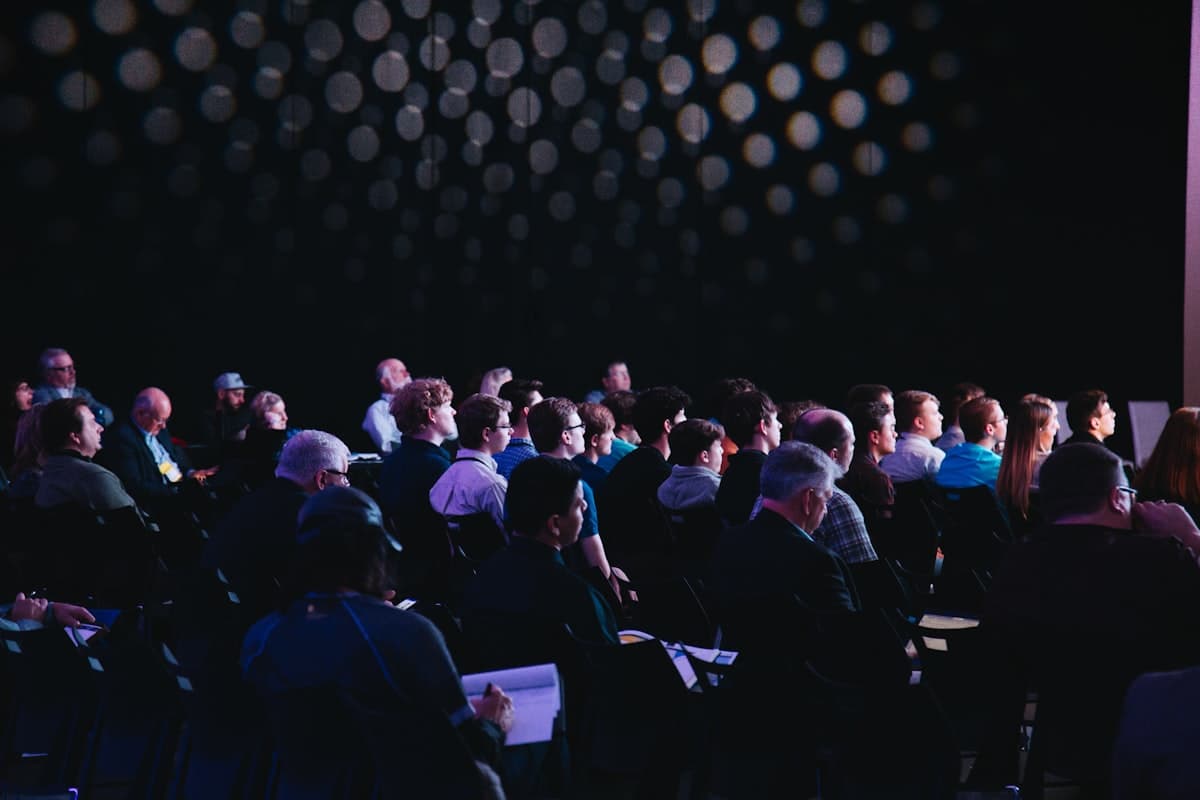 A conference audience watching a presentation