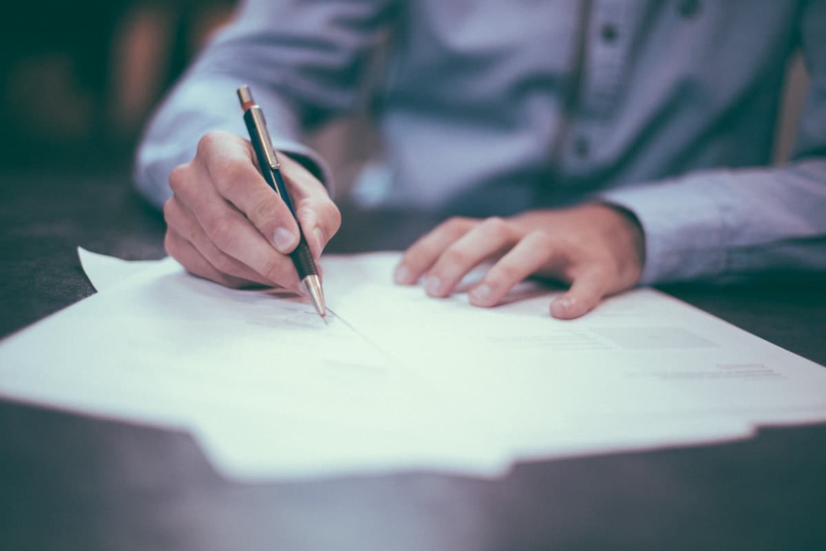 Contracts and paperwork spread on a desk