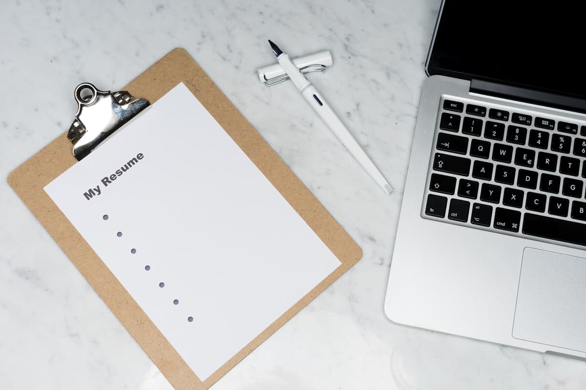 A resume and notebook on a desk